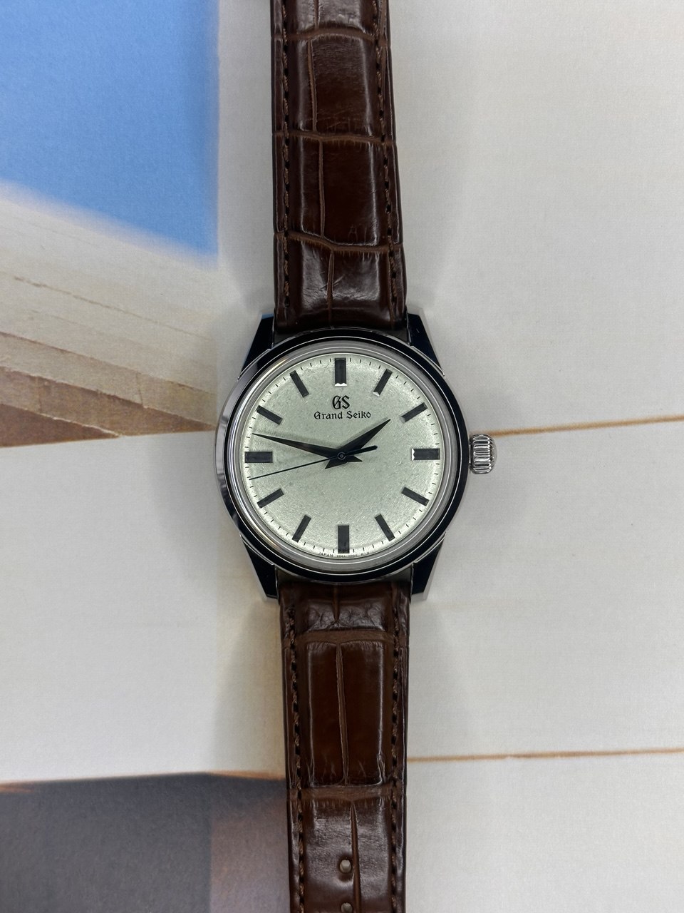 Tempora Chronos Quiet Hour completo en flat lay sobre pared Santorini